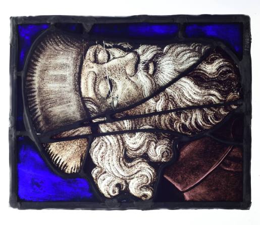 Stained glass pane with head of sleeping Jesse of Bethlehem